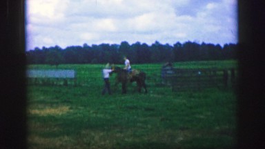 1961: two men ride their horses and go swiftly to roam the countryside IOWA