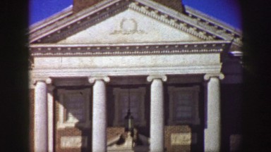 1961: men pass in front of old mansion IOWA