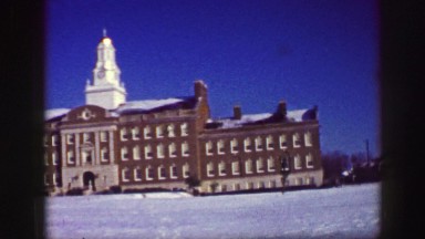 1961: a beautiful with lots of architectural details with snow on the grounds