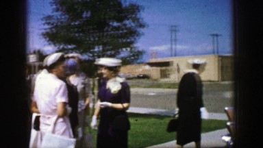 1961: a gathering is seen talking and a close up is done on a broach IOWA