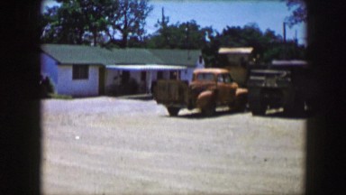 1961: view of the yard in front of a typical farmhouse. IOWA
