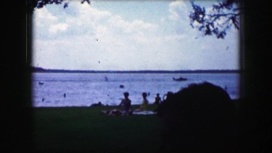 1961: a boat pulling a skier successfully across calm water. IOWA
