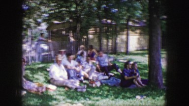 1961: people gathered in the park watching an event. IOWA