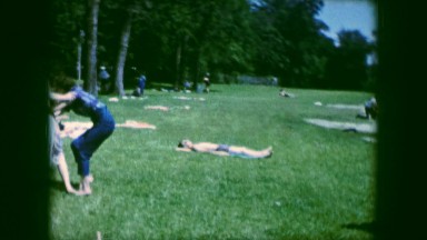 1961: woman and children wrestling and playing at a picnic IOWA