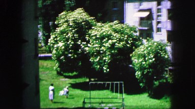 1963: Adult Taking Children to Walk Near Swings Near a Tall Building France