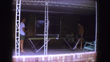 1959: Table Tennis on a Shady Ranch-Style Porch Between Two Young Men Iowa