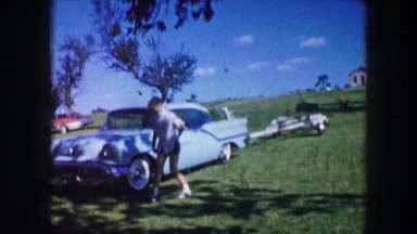 1959: a person is seen waving beside a car IOWA