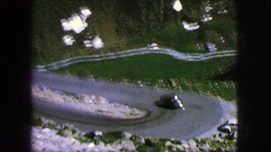 1963: vehicle driving on a winding road passing another vehicle FRANCE