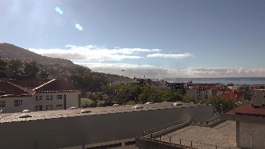 2016: Clouds Rushing Through the Sky Over Mountains and Buildings