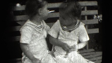 1942: Adorable Twin Girls Kiss on Park Bench in Cottonwood, Arizona