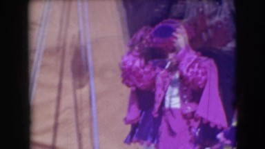 1948: purple man smoking before the circus show CHICAGO, ILLINOIS