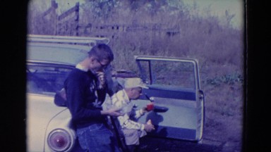 1958: Three Hunters Relaxing with Dog After Hunt in Nebraska