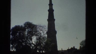 1974: People Walking on a University Campus with Stone Tower Background