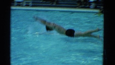 1953: two men diving into a pool during a swimming competition COTTONWOOD