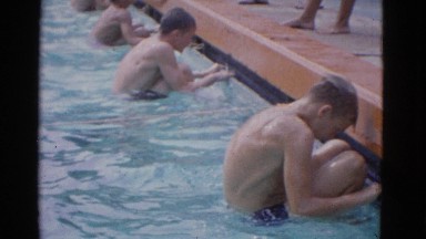 1953: young boys setting off from the edge of a swimming-pool to swim a length