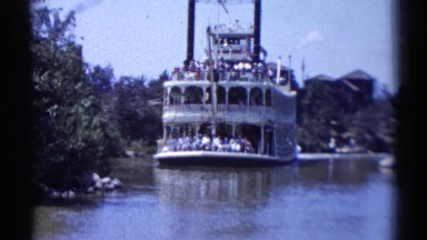 1959: retro video of a steamboat ferry full of people on a river DISNEYLAND