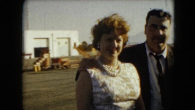 1962: Loving Couple Walk Up Ramp at Airport in Mexico City