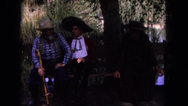 1962: a scene showing people talking with long hats is seen a man has a stick