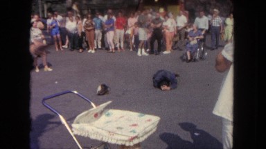 1962: person lying on ground surrounded by crowd and man with gun SAN PEDRO,