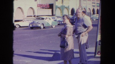 1962: man and woman waiting to cross street SAN PEDRO, CALIFORNIA