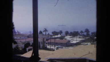 1962: looking out over the horizon that contains houses, predominantly the roofs