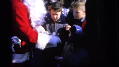 1964: santa and mrs. claus handing out candy canes to young people CAMDEN