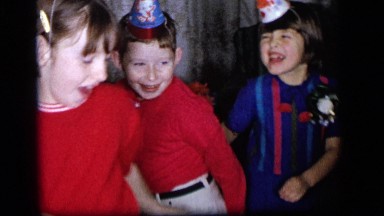 1964: playful and smiling kids dance and twist at a birthday party CAMDEN