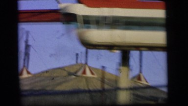 1964: driving fast past a circus on a sunny day in the family automobile CAMDEN