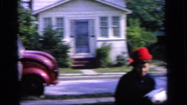 1964: woman coming home from a shopping trip. CAMDEN, NEW JERSEY