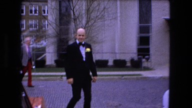 1973: A Well-Suited Chauffeur Walking Toward a Car