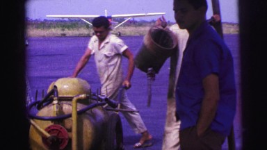 1979: People Working with Plane at Airfield in Brazil