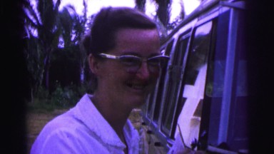 1979: younger white woman looking like she is getting on a tram or bus of some