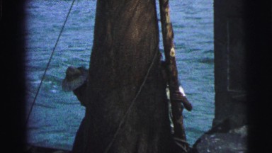 1979: men at dock working with a sail