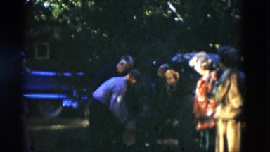 1949: Three Men Outdoors Sawing Large Log as Two Women Watch Closely