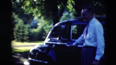 1951: man in a dress shirt and tie opening the car for a lady to get in WILLMAR