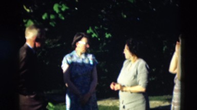 1951: older men and women gathered in a green area preparing to pose WILLMAR