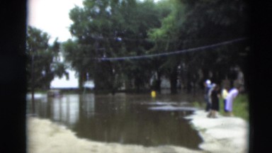 1951: a person is seen passing by water in a green area WILLMAR, KENTUCKY