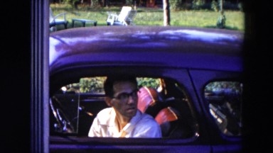 1954: waving man leaves car HICKSVILLE, NEW YORK