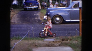 1954: young girl riding her tricycle HICKSVILLE, NEW YORK