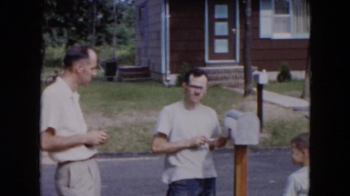 1954: two men and a boy installing a mailbox HICKSVILLE, NEW YORK