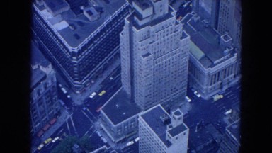 1954: a slow moving aerial view of city skyscrapers and the traffic