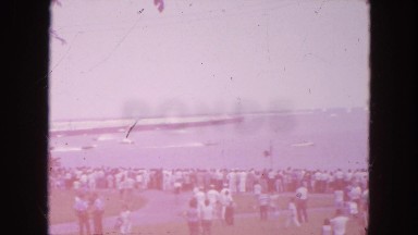 1954: a large crowd gathered seaside to watch boats racing near the shoreline
