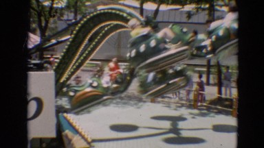 1968: various rides at a fair, including a large ferris wheel, boat traveling