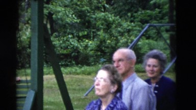 1949: people are seen overlooking at something and it seems a outdoor party.