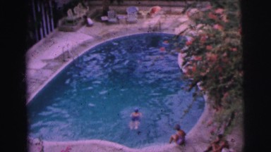 1962: A Person Swimming Freestyle in an Outdoor Pool in Bangkok, Thailand