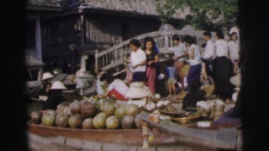1962: people selling produce on boats outdoors BANGKOK, THAILAND