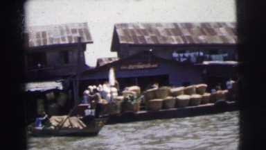 1962: view of industrial shoreline from river with people working BANGKOK,