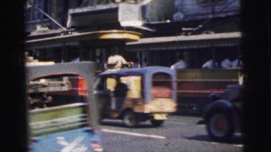 1962: lively citizens travelling down a busy street in the city BANGKOK,