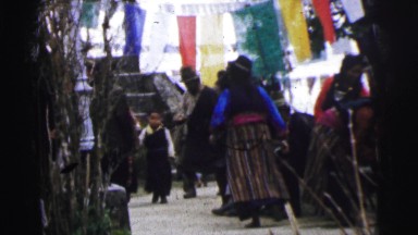1962: the scene shows a little girl walking in a busy market, and people