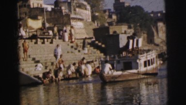 1962: people bathing in the river as a boat passes by BANGKOK, THAILAND